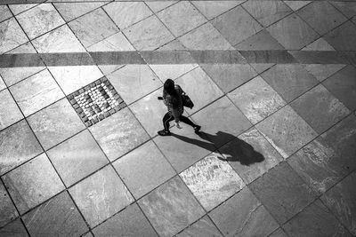 High angle view of man walking on footpath