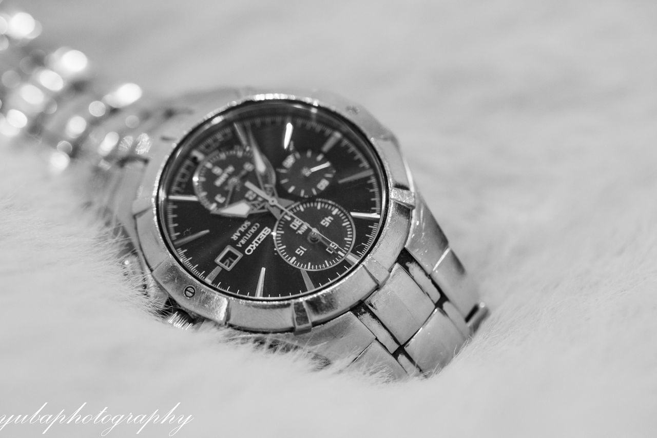 CLOSE-UP OF CLOCK ON TABLE