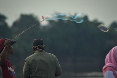 Rear view of people in mid-air