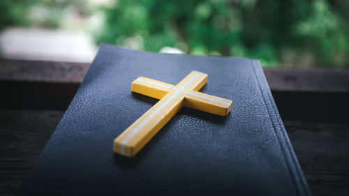 Close-up of cross on table