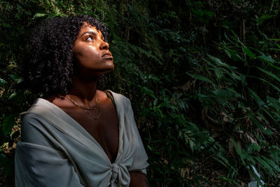 Woman looking away in forest