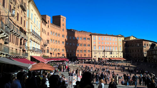 Group of people against buildings in city