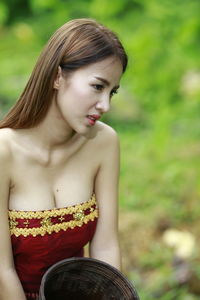 Portrait of a young woman sitting outdoors