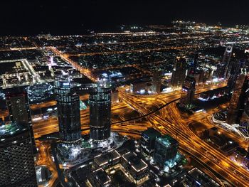 High angle view of city lit up at night