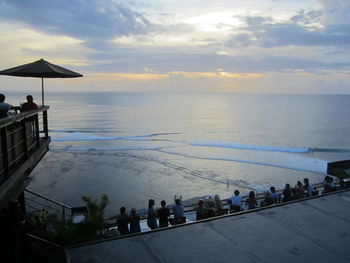 People at beach during sunset
