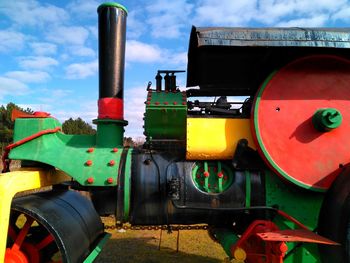 Close-up of train on field against sky