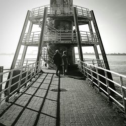 Full length of woman standing by railing