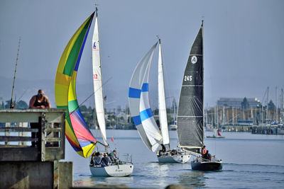 Boats sailing in sea against sky