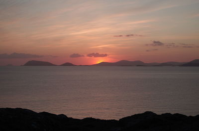 Scenic view of sea against romantic sky at sunset