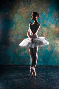 Full length of woman dancing against white background