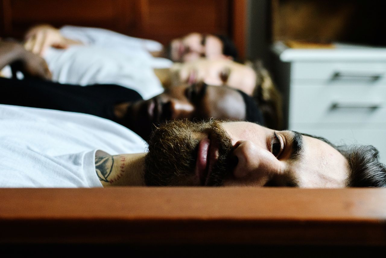 relaxation, lying down, sleeping, real people, indoors, resting, one person, eyes closed, young adult, lifestyles, selective focus, adult, men, headshot, leisure activity, portrait, furniture, tired, napping