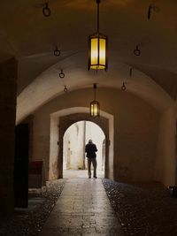 Rear view of man walking in corridor