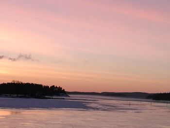 Scenic view of sea against sky at sunset