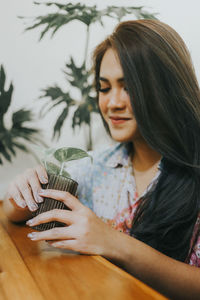 Portrait of beautiful woman holding camera
