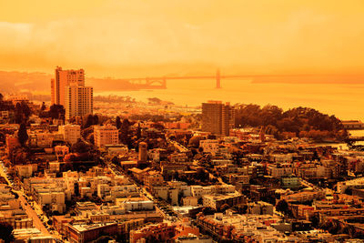 High angle view of buildings in city against sky during sunset