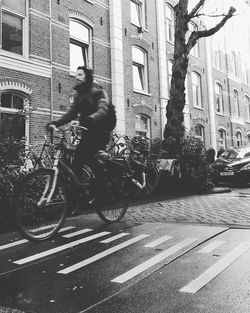 Man riding bicycle on street in city