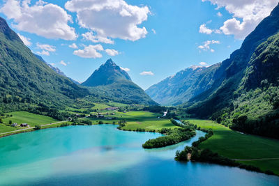 Scenic view of lake and mountains against sky