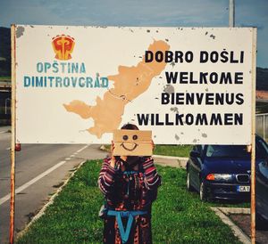 Man standing on road sign