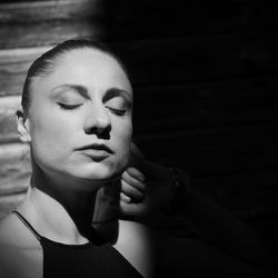 Close-up portrait of young woman with eyes closed