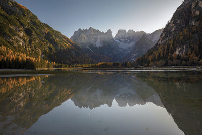 Scenic view of lake landro and mountains against sky