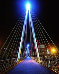 Illuminated suspension bridge at night