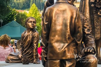 Woman sitting by statue