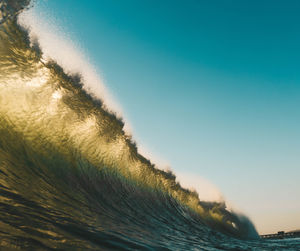 Close-up of sea against clear blue sky