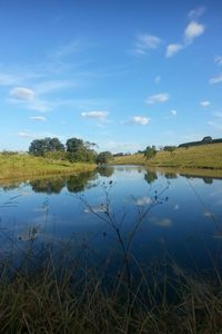 Scenic view of lake against cloudy sky