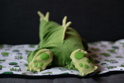 Close-up of baby wearing costume while lying on bed