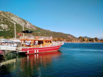 Boat in sea against clear blue sky