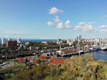 High angle view of buildings and trees against sky