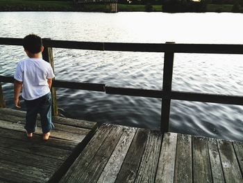 Rear view of a man overlooking water