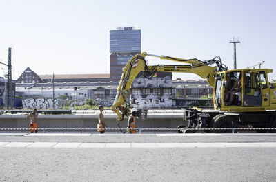 Vehicles on road against buildings in city