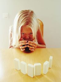 Girl having soup while sitting at table