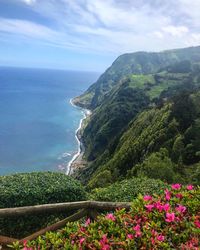 Scenic view of sea and mountains against sky