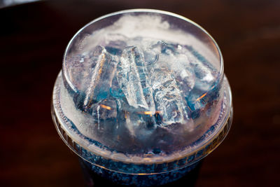 High angle view of ice glass on table