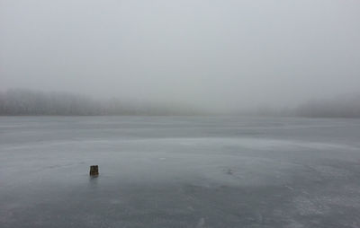 Scenic view of frozen lake against sky during winter