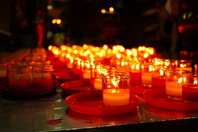 Lit tea light candles in temple