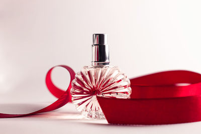 Close-up of red wine on table against white background