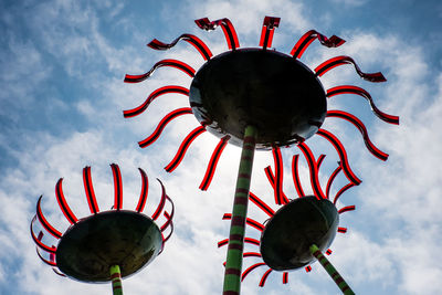 Low angle view of decorations hanging against sky