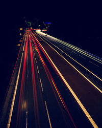 High angle view of light trails on highway at night