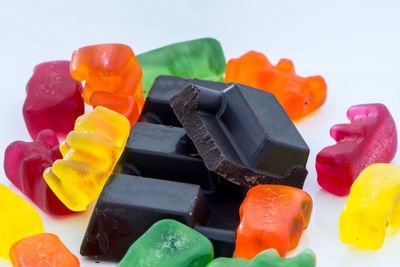 Close-up of multi colored candies against white background