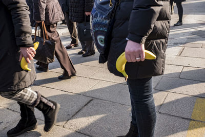 Low section of people walking on road