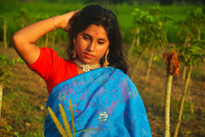 Portrait of woman standing on field
