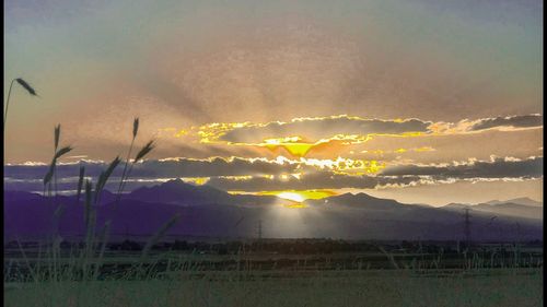 Scenic view of field against sky during sunset