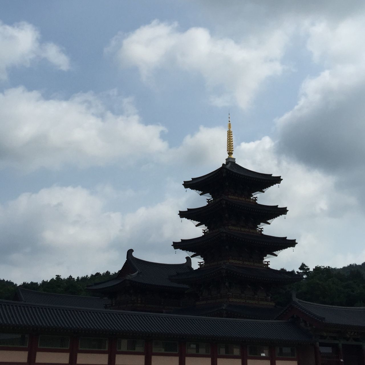 architecture, place of worship, religion, built structure, building exterior, spirituality, sky, cloud - sky, low angle view, temple - building, church, cloudy, roof, cloud, history, famous place, temple