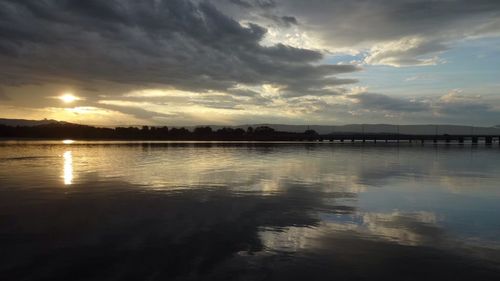 Scenic view of lake at sunset