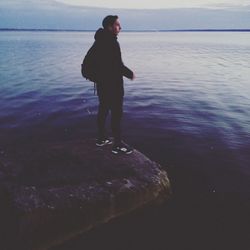 Full length of man standing on beach against sky