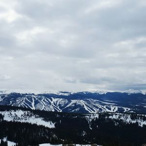 Scenic view of mountains against cloudy sky