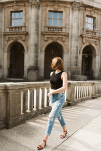 Full length rear view of woman in city